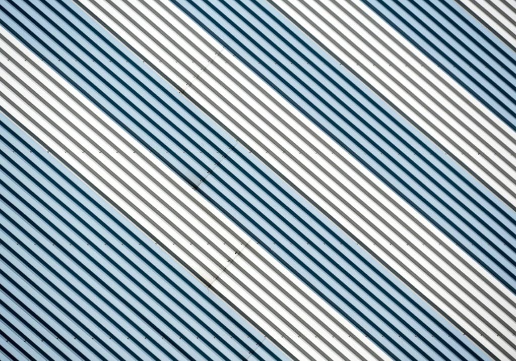 Close-up view of a sleek, silver aluminum standing seam metal roof