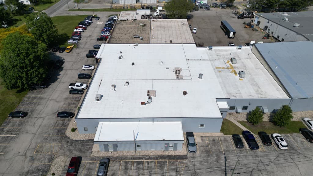 Aerial Drone View of Large Commercial Building Flat White PVC Roof