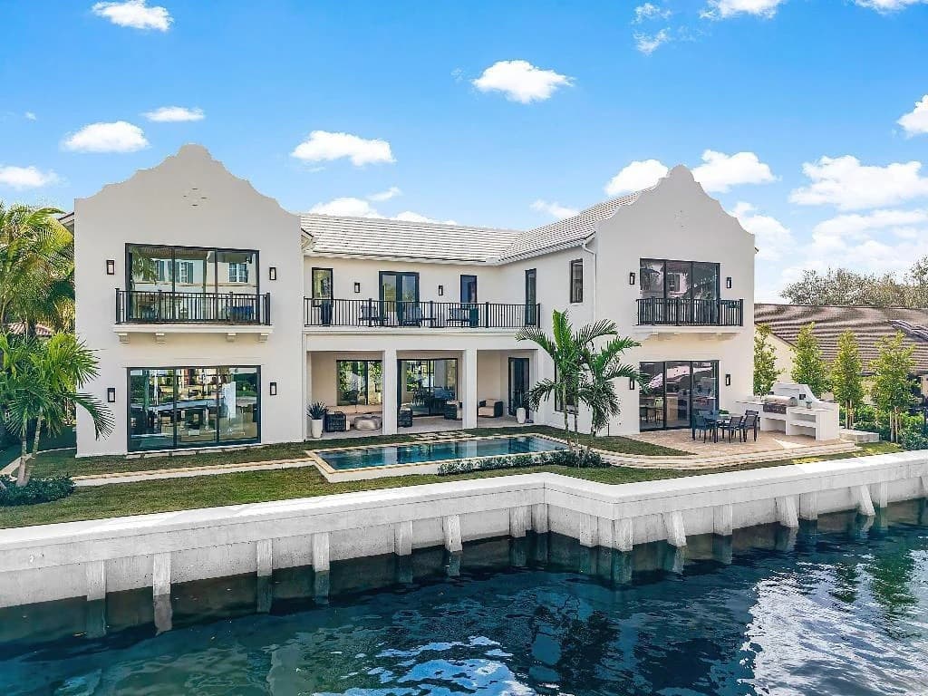 Luxury waterfront villa featuring a premium white tile roof